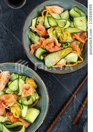 Keto salad with salmon and cucumber. 110886998