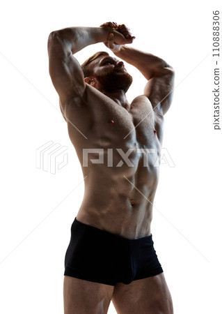 Young attractive man demonstrated his perfect body shapes against white background. Dieting and fitness. Sport and workout. 110888306