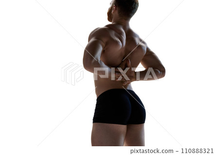 Rear view photo of young, athlete naked man demonstrated his perfect and healthy back shape against white studio background. 110888321