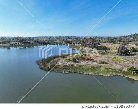 Aerial view over water reservoir and a large dam that holds water. Rancho Santa Fe in San Diego 110889377