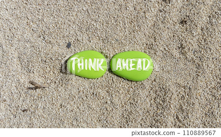 Think ahead symbol. Concept words Think ahead on beautiful green stone on a beautiful sand sea beach background. Business, support, motivation, psychological and think ahead concept. Copy space. 110889567