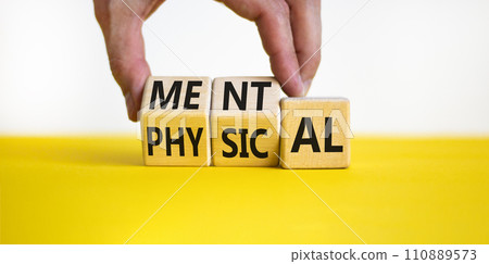 Mental or physical symbol. Concept word Mental or Physical on wooden cubes. Beautiful yellow table white background. Doctor hand. Business lifestyle and mental or physical concept. Copy space. 110889573