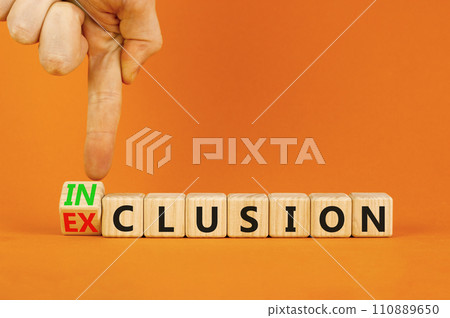 Inclusion or exclusion symbol. Concept word Exclusion and Inclusion on wooden cubes. Businessman hand. Beautiful orange table orange background, copy space. Business inclusion or exclusion concept. 110889650