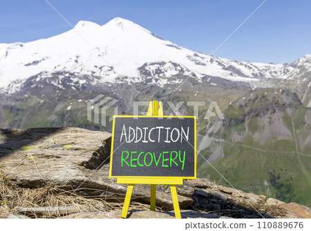 Addiction recovery symbol. Concept words Addiction recovery on beautiful black chalk blackboard. Beautiful mountain Elbrus blue sky background. Psychology addiction recovery concept. Copy space. Addiction recovery symbol. Concept words Addiction recovery on beautiful black chalk blackboard. Beautiful mountain Elbrus blue sky background. Psychology addiction recovery concept. Copy space. 110889676