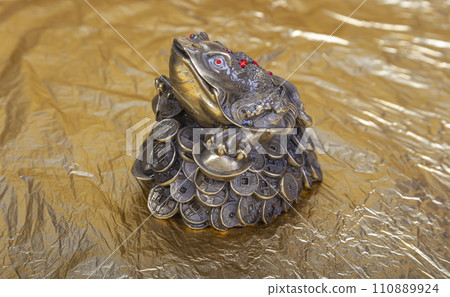 Money toad by Feng Shui. A money frog with a coin( 5 ruble Iron coins-- written five rubles, the Bank of Russia) in its mouth. The statuette is a Chinese money toad that brings wealth Money toad by Feng Shui. A money frog with a coin( 5 ruble Iron coins-- written five rubles, the Bank of Russia) in its mouth. The statuette is a Chinese money toad that brings wealth 110889924