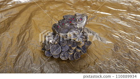 Money toad by Feng Shui. A money frog with a coin( 5 ruble Iron coins-- written five rubles, the Bank of Russia) in its mouth. The statuette is a Chinese money toad that brings wealth 110889934