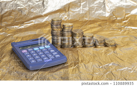 Calculator and 10 ruble Iron coins (written ten rubles, the Bank of Russia). Finance and business concept Calculator and 10 ruble Iron coins (written ten rubles, the Bank of Russia). Finance and business concept 110889935