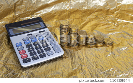 Calculator and 10 ruble Iron coins (written ten rubles, the Bank of Russia). Finance and business concept Calculator and 10 ruble Iron coins (written ten rubles, the Bank of Russia). Finance and business concept 110889944