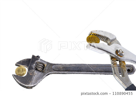 Allegory of the global financial crisis - Iron 10 rubles coin (written ten rubles, the Bank of Russia) in the grip of economic crisis, on a white background. Finance and business concept Allegory of the global financial crisis - Iron 10 rubles coin (written ten rubles, the Bank of Russia) in the grip of economic crisis, on a white background. Finance and business concept 110890455