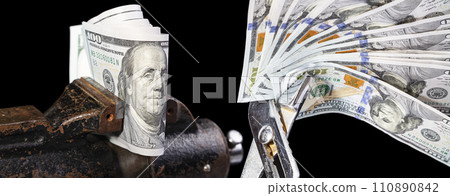 Allegory of the global financial crisis - U.S. dollars in the grip of economic crisis, on a black background 110890842