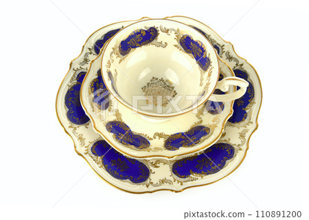 Vintage porcelain tea cup, saucer and dessert plate isolated on white. 110891200