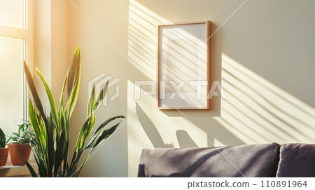 Blank wooden poster frame mock up template, room interior in fusion style with white walls, dark sofa and many green plants. Play of light and shadow 110891964