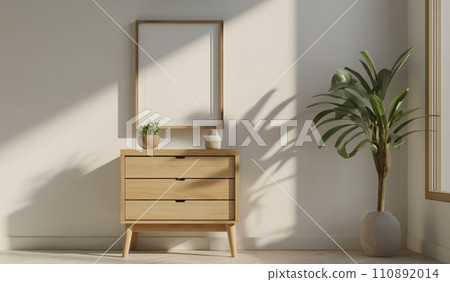 Blank wooden poster frame mock up template, room interior in fusion style, white walls on background, wooden dresser and green plant. Ray of sun 110892014