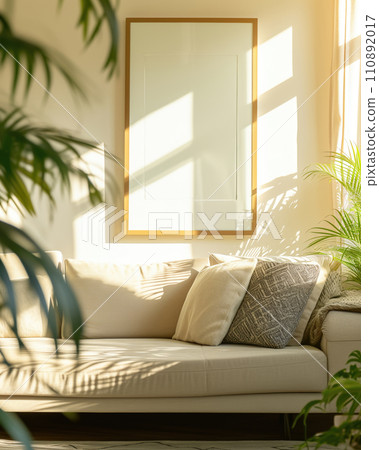 Blank wooden poster frame mock up template, room interior in fusion style with white walls, cozy white sofa and many green plants. Play of light and shadow 110892017