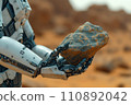 humanoid robot exploring a mineral sample on the planet Mars 110892042