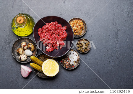 Cooking savory beef tartare and brown bread toasts Cooking savory beef tartare and brown bread toasts 110892439