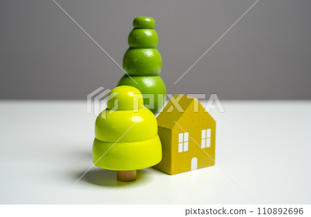 Figures of a house and trees. Design, construction and reconstruction of buildings. Create a dream home. Buy with a mortgage. Garden work, landscape design. 110892696