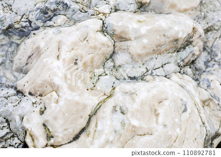 Glossy natural stone, untreated. Background, wallpaper. Beautiful background made of untreated wild stone. 110892781