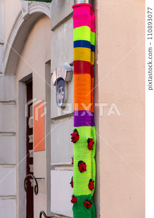 A downpipe wrapped in a colorful bright knitted fabric A downpipe wrapped in a colorful bright knitted fabric 110893077