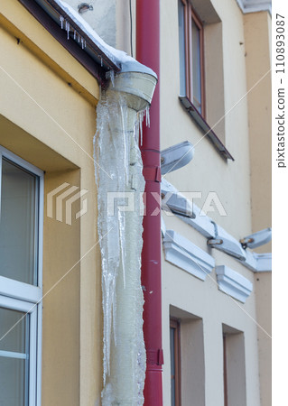 Big icicles on the roof of a townhouse Big icicles on the roof of a townhouse 110893087