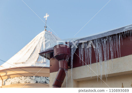 Big icicles on the roof of a townhouse Big icicles on the roof of a townhouse 110893089