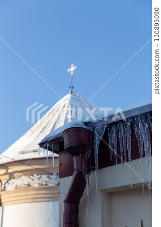Big icicles on the roof of a townhouse Big icicles on the roof of a townhouse 110893090
