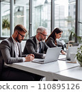 Businesspeople working on a laptops in an office with white walls, wide windows, dressed according to the business dress code and focused on work 110895126