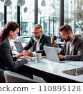 Businesspeople working on a laptops in an office with white walls, wide windows, dressed according to the business dress code and focused on work 110895128