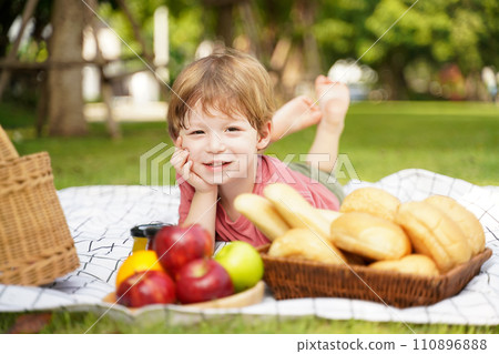 Happy family picnic in the park public on summer holiday. Family boy relax and enjoying outdoor. Happy family picnic in the park public on summer holiday. Family boy relax and enjoying outdoor. 110896888