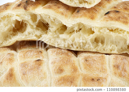 Pita flat-bread toasted of a grid pattern over white Pita flat-bread toasted of a grid pattern over white 110898380