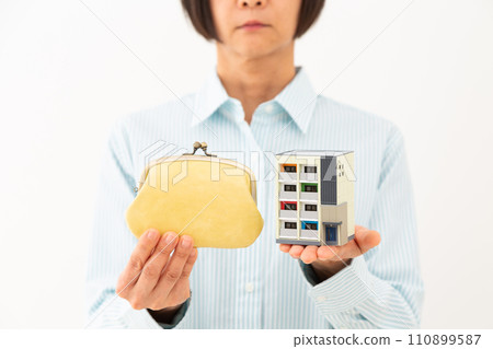 A woman with a wallet and a model of an apartment 110899587