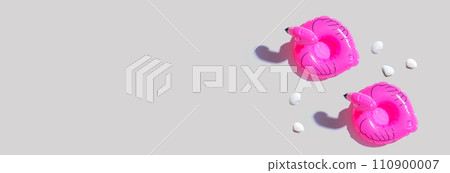 Summer concept with pink flamingo floats Summer concept with pink flamingo floats 110900007