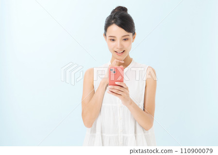 Woman holding a smartphone Woman holding a smartphone 110900079