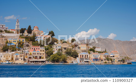 Symi Island, Greece. Greece islands holidays from Rhodos in Aegean Sea. Colorful neoclassical houses in bay of Symi. Holiday travel background. 110900327