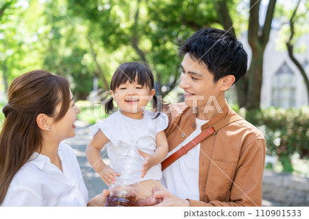 Baby drinking tea, parent and daughter, family of three Baby drinking tea, parent and daughter, family of three 110901533