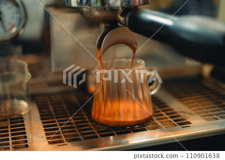 Coffee from the machine in the cafe,Coffee flows into the glass Coffee from the machine in the cafe,Coffee flows into the glass 110901638