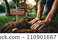 Young Tree Planting in Park with Wellness Sign 110901667