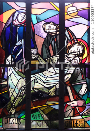 14th Stations of the Cross, Jesus is laid in the tomb and covered in incense, stained glass window in Saint Lawrence church in Kleinostheim, Germany 110903374