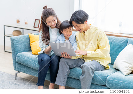 Close family looking at a computer 110904191