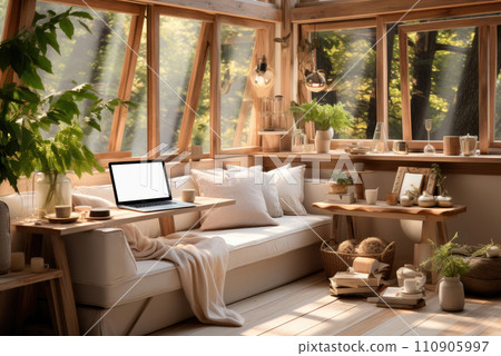 Comfortable workplace or study place at home by the window and sofa with an open laptop 110905997