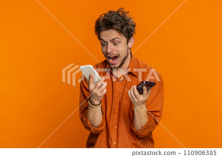 Irritated stressed business man talking on two mobile phones having conversation conflict quarrel Irritated stressed business man talking on two mobile phones having conversation conflict quarrel 110906385