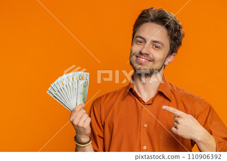 Rich happy man winner waving money dollar cash like a fan, big income wealth success business Rich happy man winner waving money dollar cash like a fan, big income wealth success business 110906392