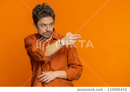 Young man pointing around with finger gun gesture making choice, shooting killing with hand pistol 110906458