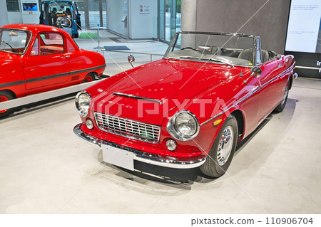 A bright red Datsun Fairlady 1500 on display in the showroom 110906704