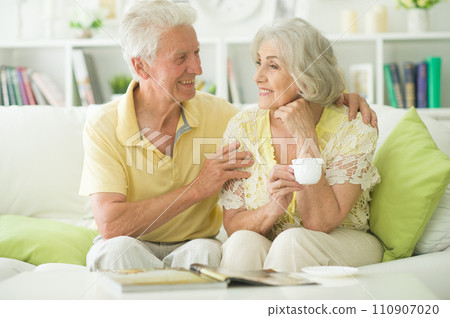 Portrait of mature couple with magazine drinking tea Portrait of mature couple with magazine drinking tea 110907020