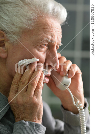 Portrait of sad sick senior man calling doctor Portrait of sad sick senior man calling doctor 110907039