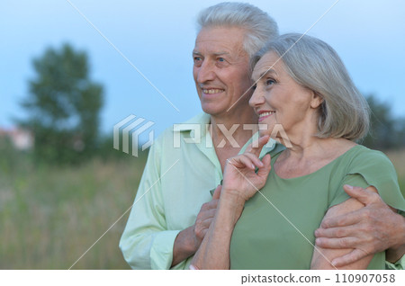 Loving mature couple on a walk in the park  Loving mature couple on a walk in the park  110907058