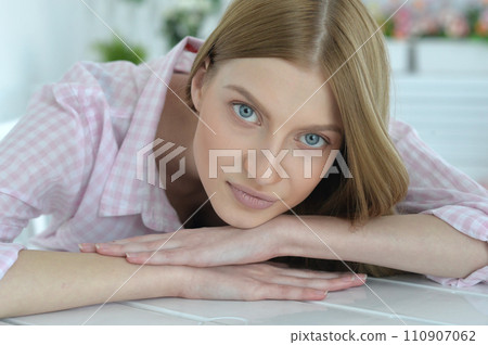 Portrait of young woman with deep blue eyes 110907062