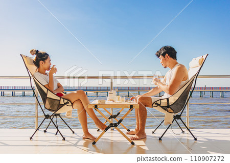 Asian couple lover enjoy their holiday at the sea in the summer with beautiful clear sky ocean view. 110907272
