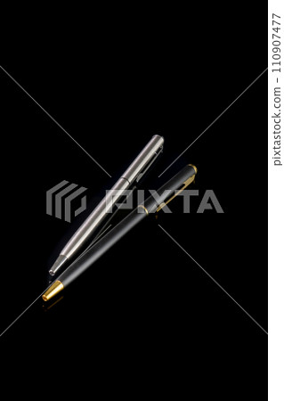 Ball pen duo silver and gold luxury. Two ball pens for signature in business solated on black background Ball pen duo silver and gold luxury. Two ball pens for signature in business solated on black background 110907477